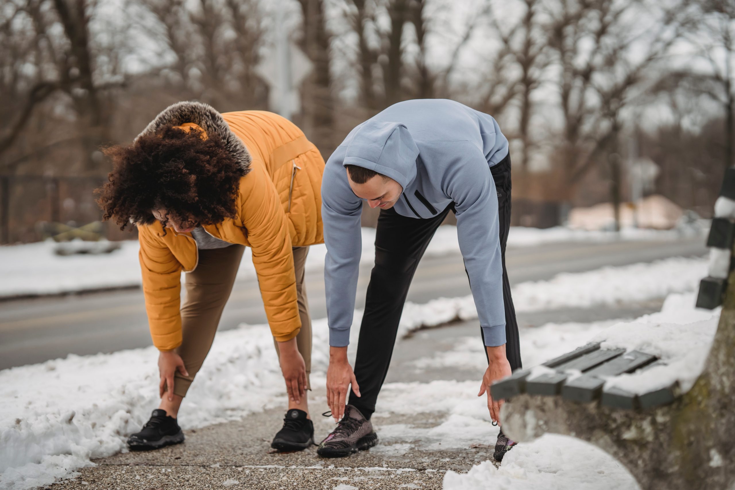 Two humans exercising outside in the winter