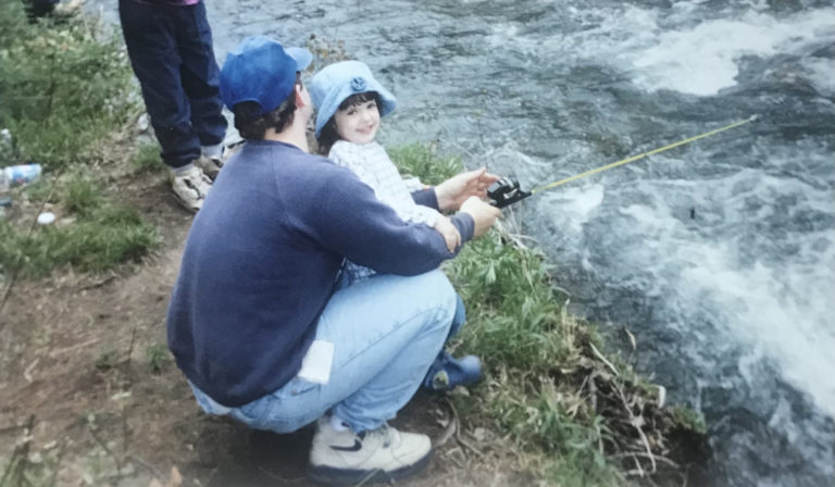 Katie fishing with her dad outside