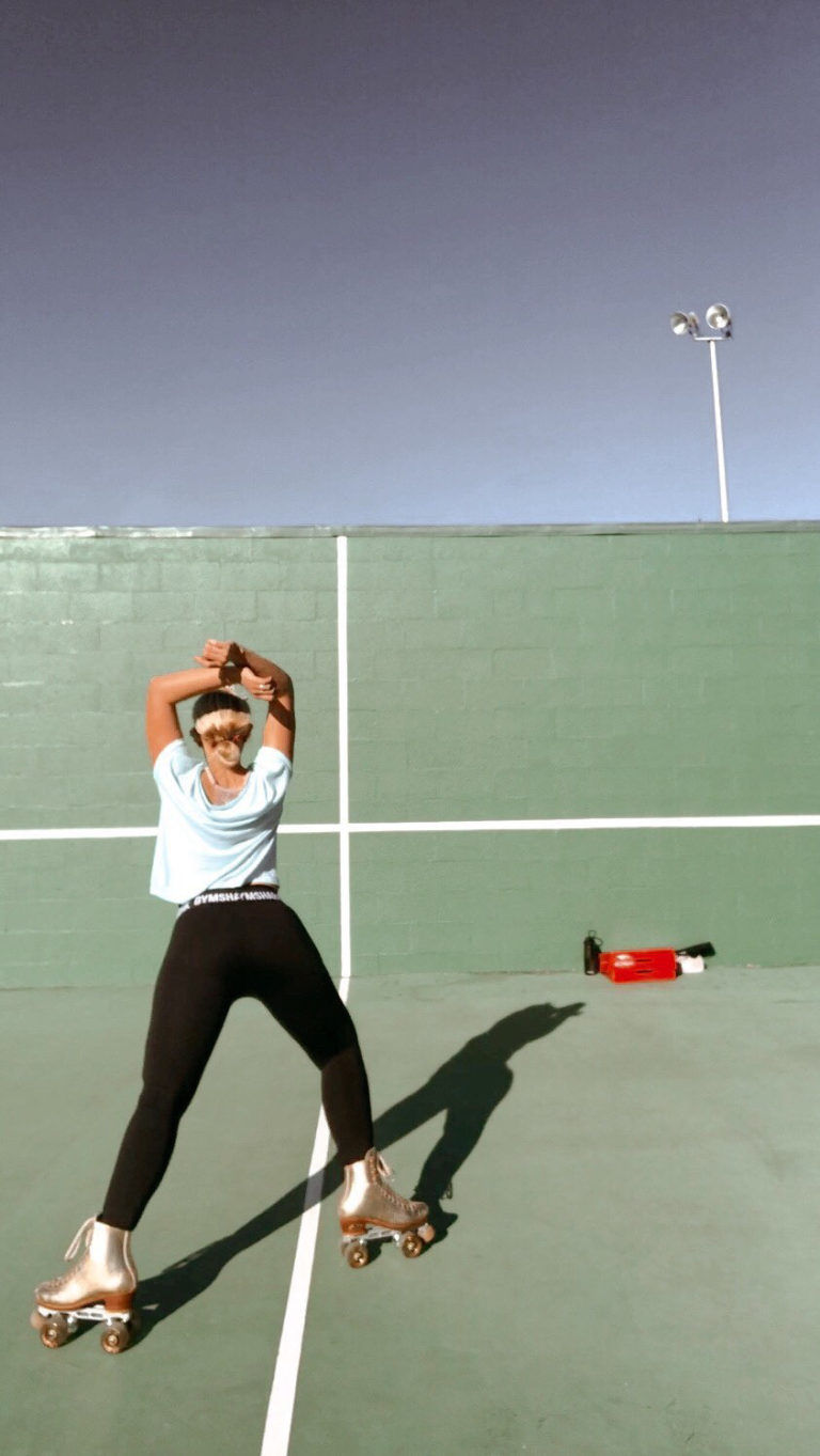 Abby skating in a tennis court